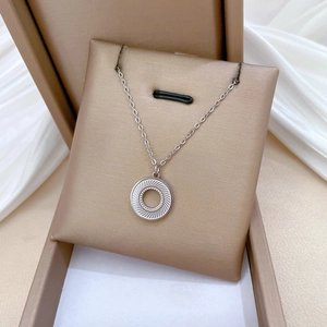 Minimalist spinning round circle titanium steel necklace on white silk in jewelry box