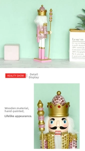 Detail of hand-painted wooden pink and gold nutcracker king with sparkling crown