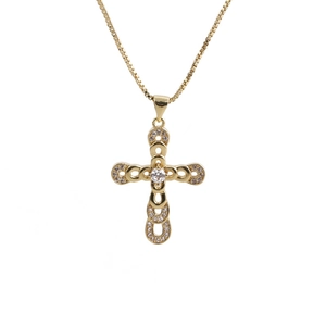 Macro shot of gold-plated cross pendant with white zircon stones on a box chain