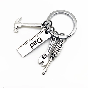Detailed close-up of Father's Day keychain with mini hammer, wrench, and Dad engraved charm