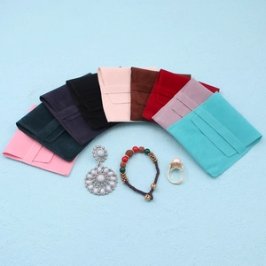 Multiple macaron colored suede jewelry pouches displayed in a fan-shaped radial layout