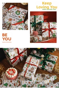 Detail of Christmas wrapping paper with cartoon patterns and Merry Christmas satin ribbons