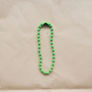 Detail of 2.4mm green painted bead chain with connector on brown kraft paper
