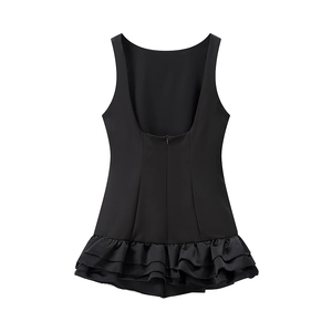 Detail of black backless mini dress featuring layered ruffles and invisible zipper closure