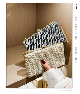Detail of chevron pattern acrylic clutch bags with crystal clasp and gold chain strap