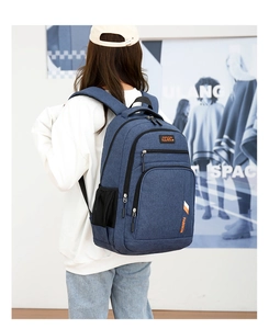 Detailed back view of navy blue business backpack featuring multiple zip compartments