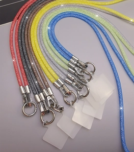 Detailed view of colorful rhinestone mesh phone lanyards with metal hooks and inserts
