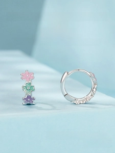 Detail of S925 sterling silver hoop earrings with pink green purple enamel flowers