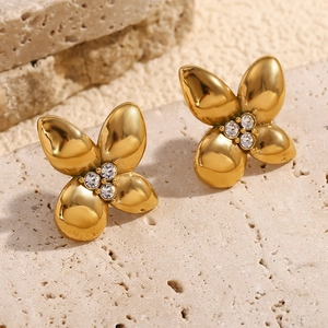 Macro detail of 18K gold-plated flower earrings with four inset white diamonds