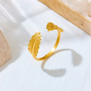 Detailed macro view of an adjustable golden leaf feather ring with serrated textures