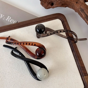 Vintage shark hair clips in black, brown and grey with spherical bead accents on wood
