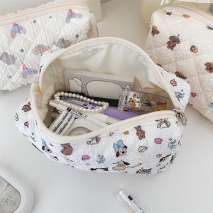 Detail showing high-capacity quilted stationery bag with cute animal patterns and metal zipper