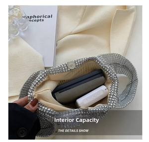 Detail view of silver rhinestone handbag interior showing capacity for phone and wallet