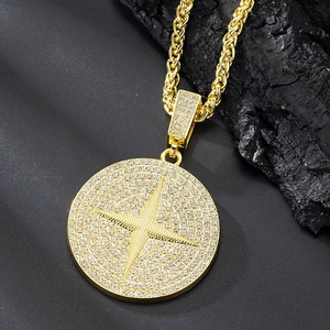 Close-up of golden hip hop star pendant with iced-out crystals on a twist chain