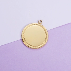Polished gold circular titanium steel pendant with decorative rope edge on dual-tone background