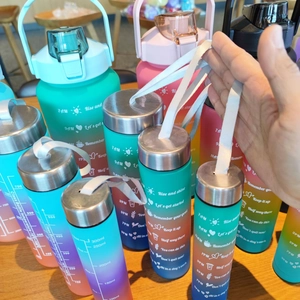 Detail of gradient frosted water bottles with measurement scales and carrying ropes