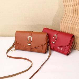 Detail of multi-compartment crossbody phone bag with pebble texture and metal buckle