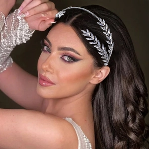 Close-up of bridal headband with sparkling leaf-shaped rhinestones and silver finish
