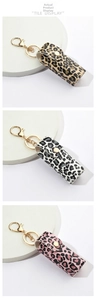 Detail of leopard print PU leather lipstick holder keychain in three colors with gold clasp