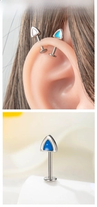 Detailed view of F136 titanium triangle cat ear studs in multiple colors on ear model