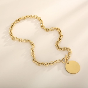 Close-up of polished gold OT toggle clasp and engravable round pendant on chain
