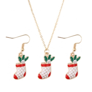 Detailed close-up of gold Christmas stocking jewelry set with red enamel and small crystal