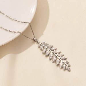 Macro shot of silver leaf pendant showing delicate vein textures and 304 stainless steel chain