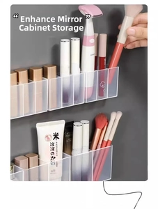 Macro shot of wall-mounted clear acrylic storage box organizing brushes and lipsticks