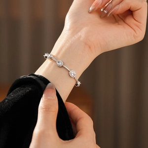 Detailansicht eines eleganten Silberarmbands mit ovalen Zirkonia-Steinen am Handgelenk