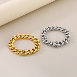 Detail of 13mm gold and silver Cuban link bracelets with high-polish finish and box clasp