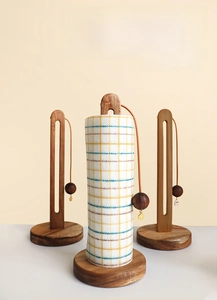 Detail of solid wood kitchen towel holders with natural grain and beaded weighted cord