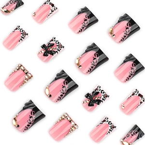 Y2K duckbill flared press-on nails with pink leopard print, 3D bows, and shiny rhinestones