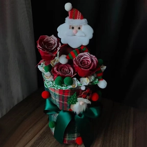 Christmas gift box with red roses, Santa Claus plush, and green plaid fabric wrap