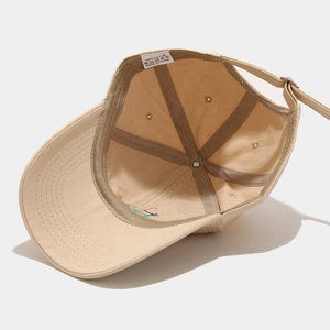 Interior view of beige cotton baseball cap showing stitching, inner lining, and size strap