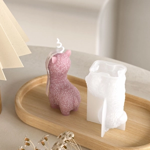 Macro detail of pink alpaca candle texture and split silicone mold on wooden tray