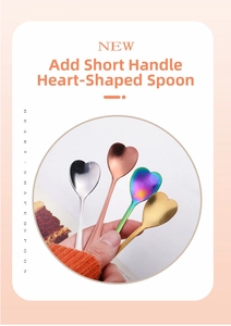 Close-up of four colored heart-shaped stainless steel spoons for coffee and dessert