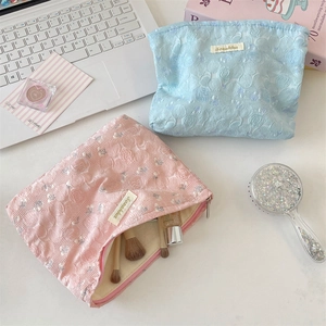Detailed top view of floral lace jacquard cosmetic bags with rose texture and inner storage