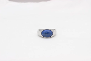 Detailed macro view of an oval lapis lazuli stone set in a wide silver stainless steel ring