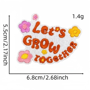 Detail of Let's GROW together embroidery patch with colorful floral patterns on felt base