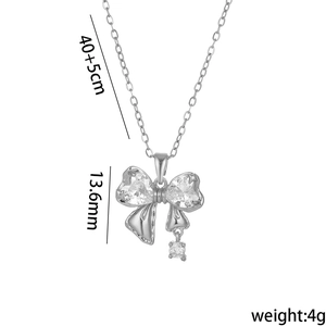 Silver butterfly bow necklace with zircon heart pendants on white background