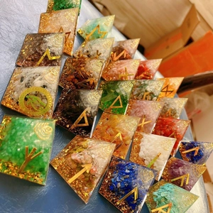 Macro shot showing diverse orgone crystal pyramids with gemstone chips and metal foils