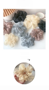 Detail of oversized organza hair scrunchies showing sheer fabric texture and soft luster
