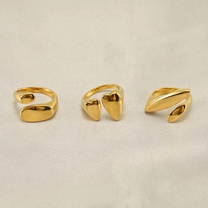 Detailed view of three gold-plated titanium steel rings featuring oval and heart shapes