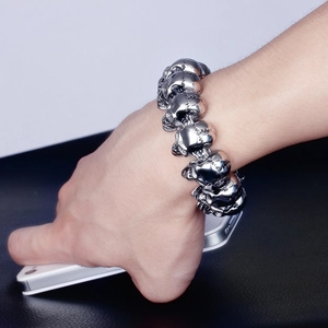 Close-up of gothic skull head bracelet in antique silver finish on male wrist