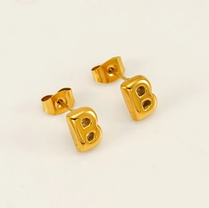 Macro detail of 3D bubble letter B stud earring in polished 18K gold plated finish