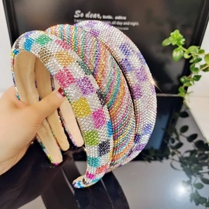 Close-up of geometric and striped colorful rhinestone headbands with padded beige lining