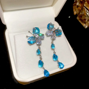 Detail of blue zirconia butterfly tassel earrings in a gift box with s925 silver finish