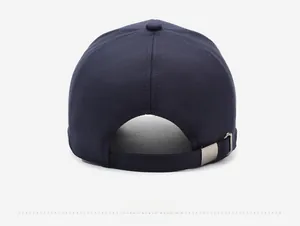 Detail view of navy cotton baseball cap with adjustable strap and metal buckle fastener