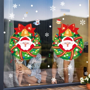 Christmas window decals with Santa Claus wreath and snowflakes on glass background