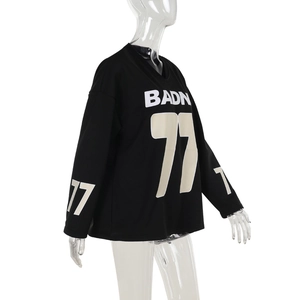 Side view of black oversized sweatshirt with BADN 77 print and athletic graphic details